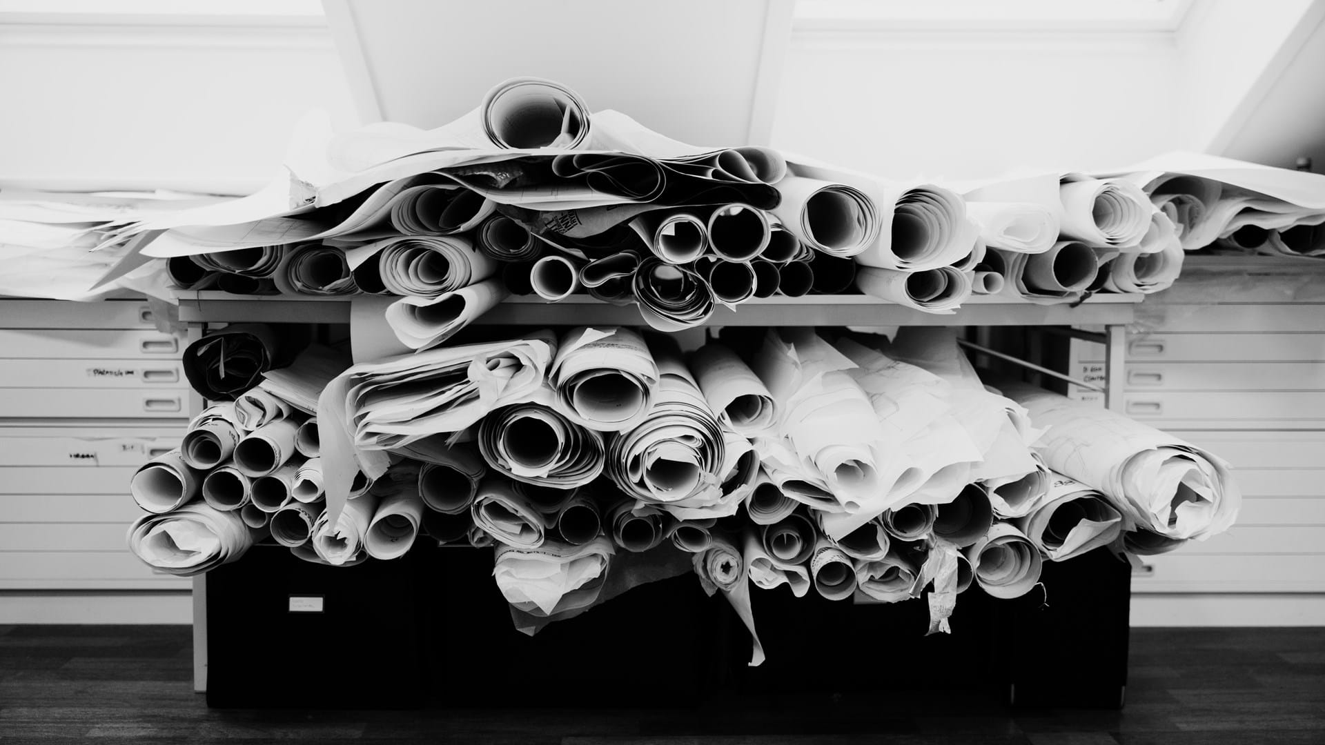 Showing the storage of old sketches, folded and stowed away in a shelf